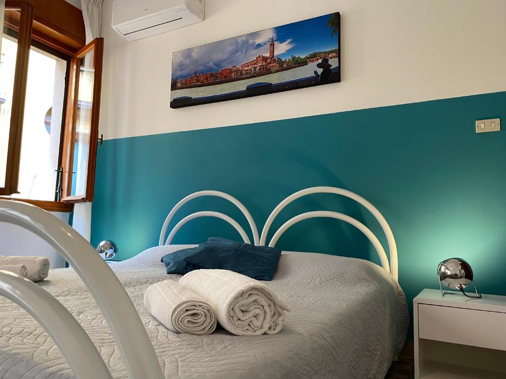 um quarto com uma cama com uma parede azul em All'Arena em Verona