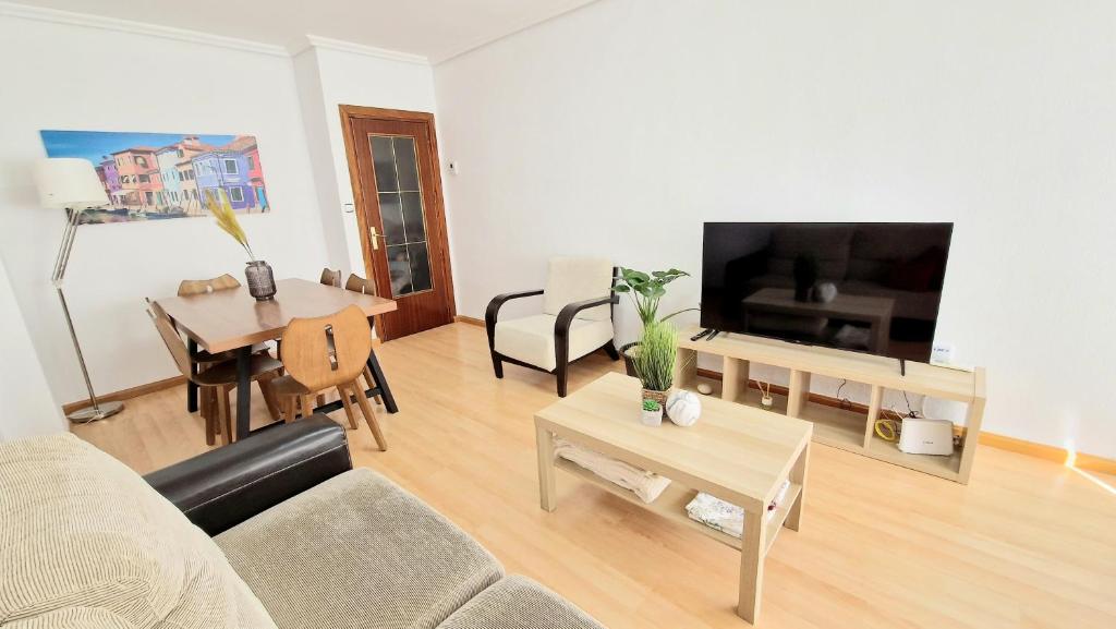 a living room with a couch and a table at Apartamento ZONA in Albacete
