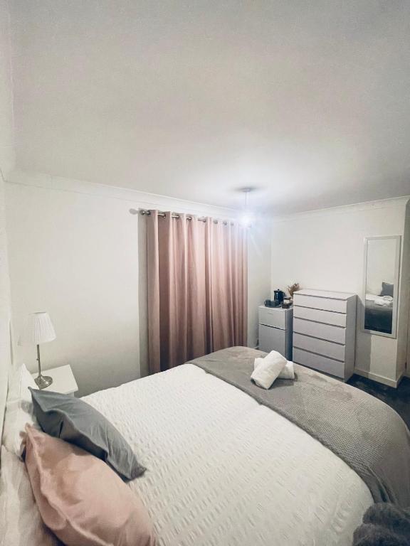 a bedroom with a large bed and a mirror at Family Room close in Bristol