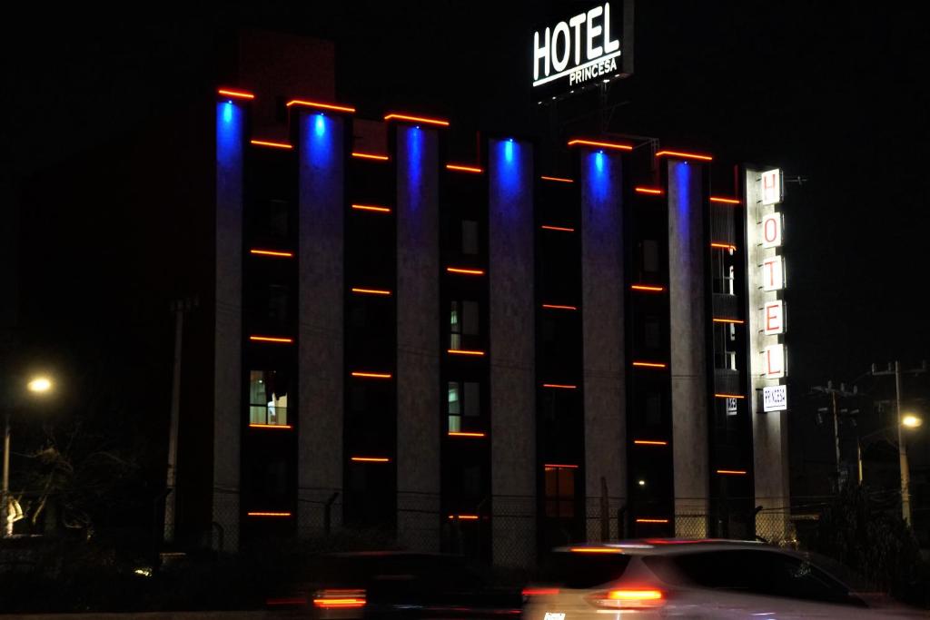 a hotel building with blue and red lights on it at Hotel Princesa in Mexico City