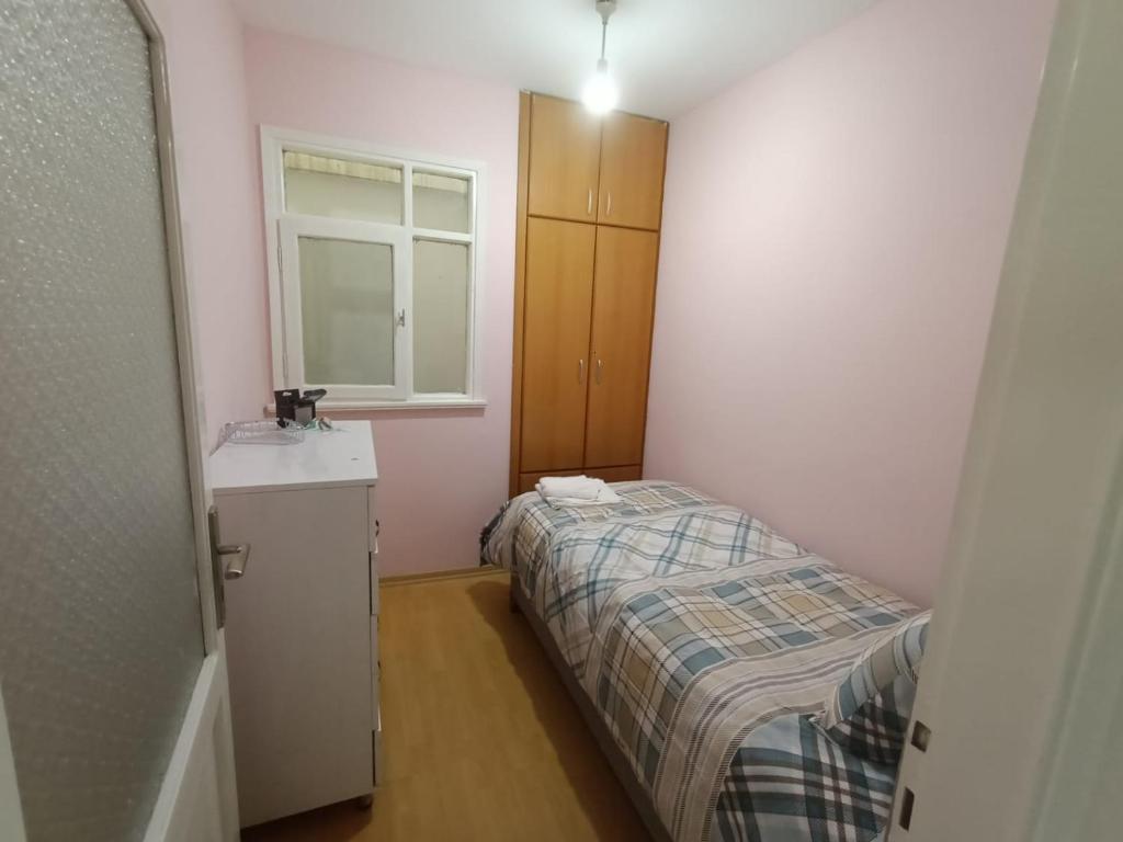 a small bedroom with a bed and a sink at Apart in Istanbul