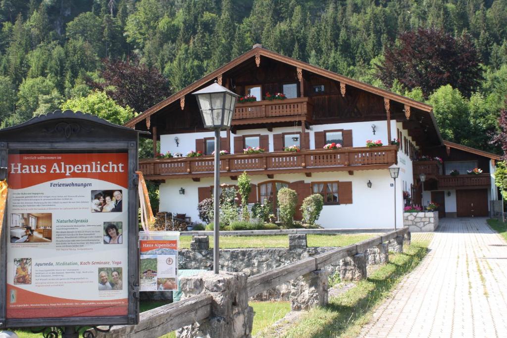 a house with a sign in front of it at Haus Alpenlicht in Reit im Winkl