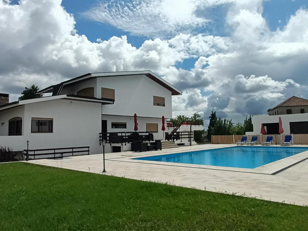 a villa with a swimming pool and a house at Aparthotel QuintadaCostinha Alijó Douro in Alijó