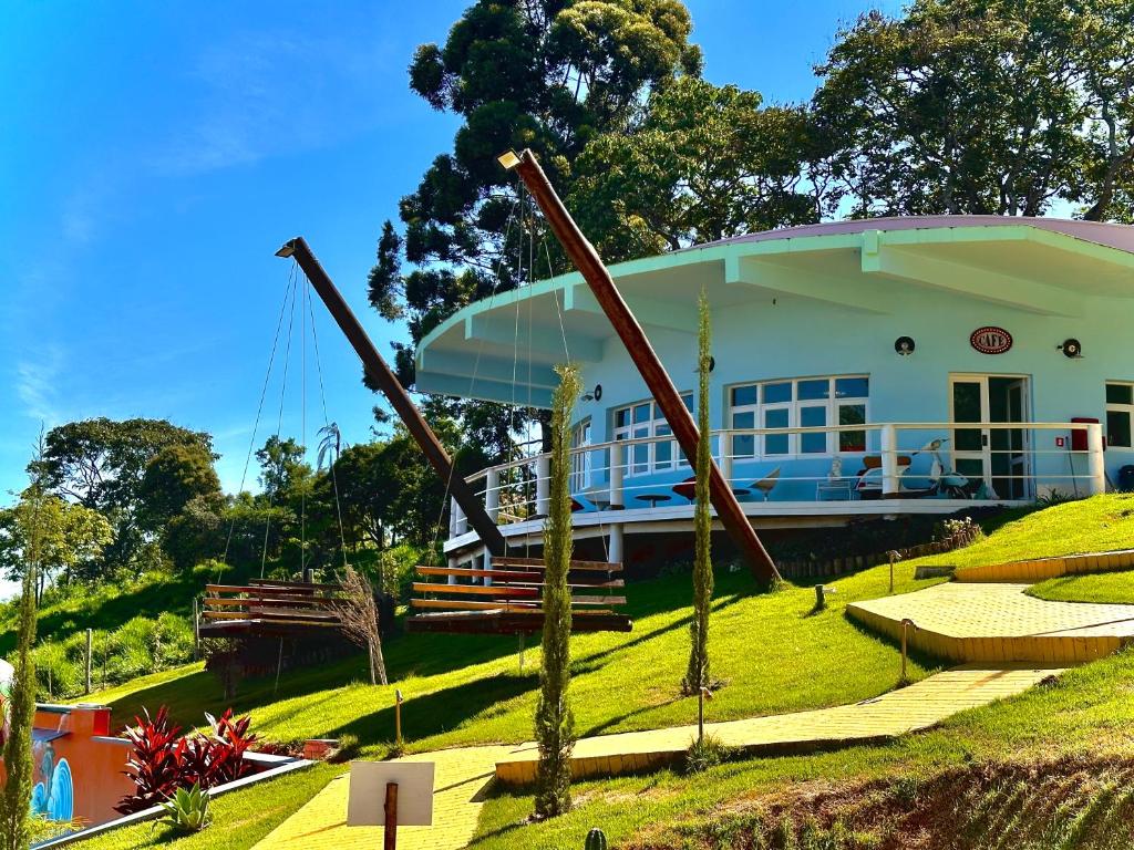a house with a sculpture in front of it at Vila Mágica Pousada in Bueno Brandão