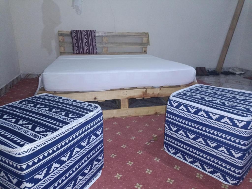 łóżko i dwa pudła w pokoju w obiekcie Jamagere Homes near Palm Oasis w mieście Garissa