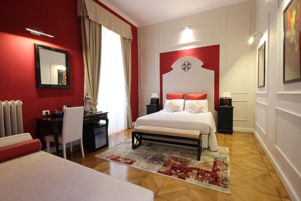 a bedroom with a white bed and red walls at Residenza L'angolo di Verona in Verona