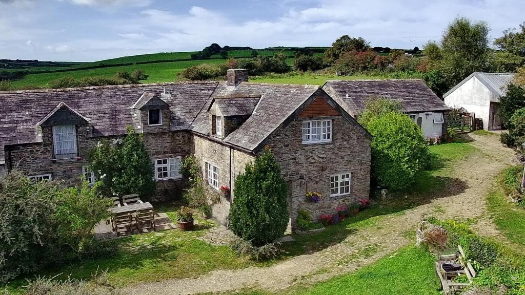 an aerial view of a stone house in the countryside at Old Newham Farm in Camelford