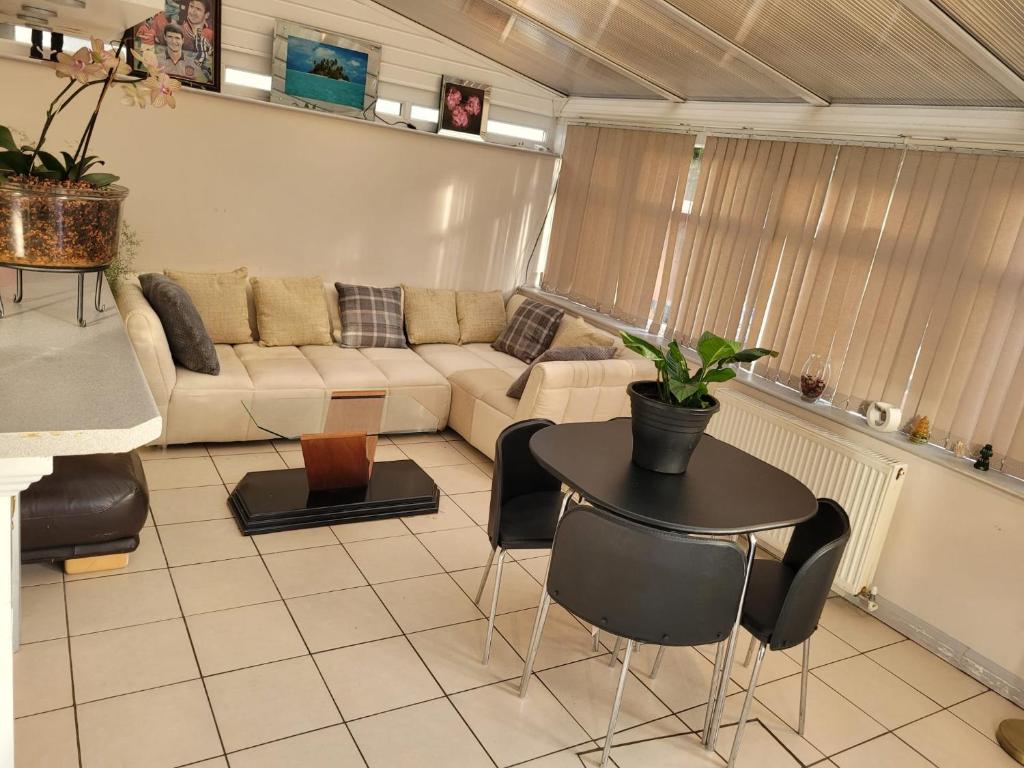 a living room with a couch and a table at Abakwa House in Kingsthorpe