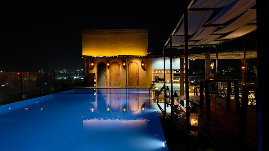 a night view of a swimming pool on top of a building at Historia Royal in Udaipur