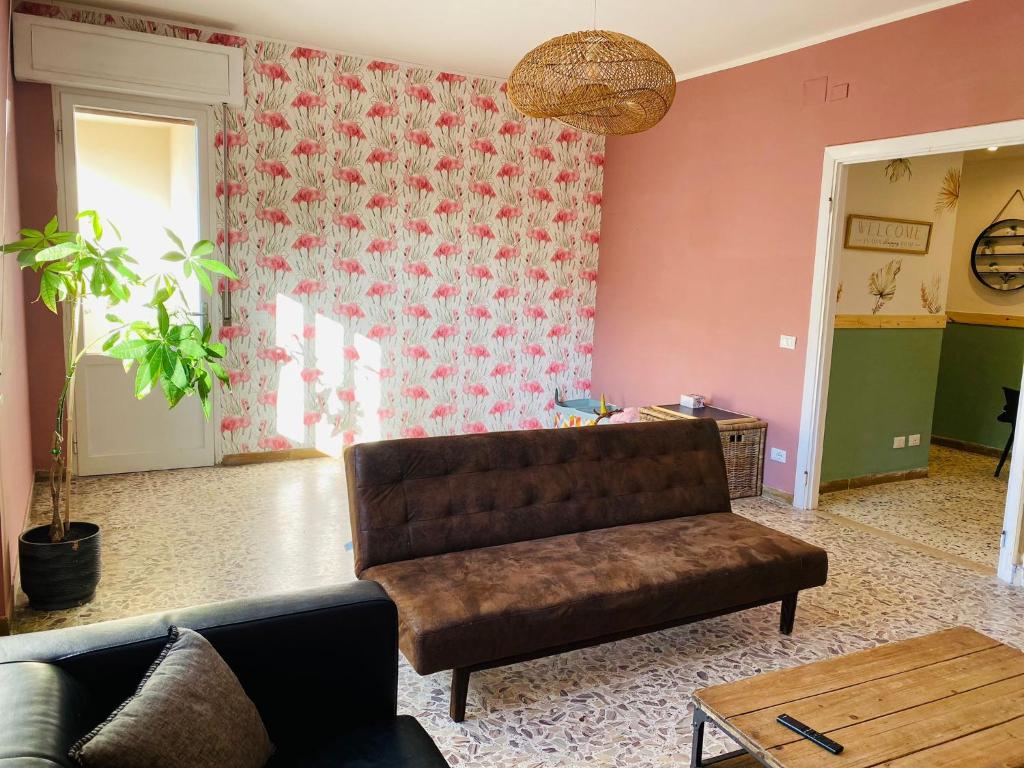a living room with a couch and a table at Jane's Apartment Rental in Pisa