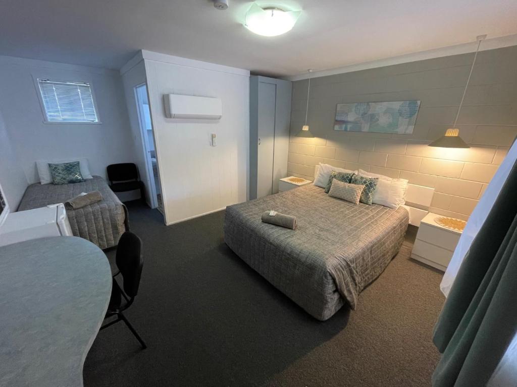 um quarto de hotel com uma cama e uma mesa em Hatton Vale Motel em Hatton Vale