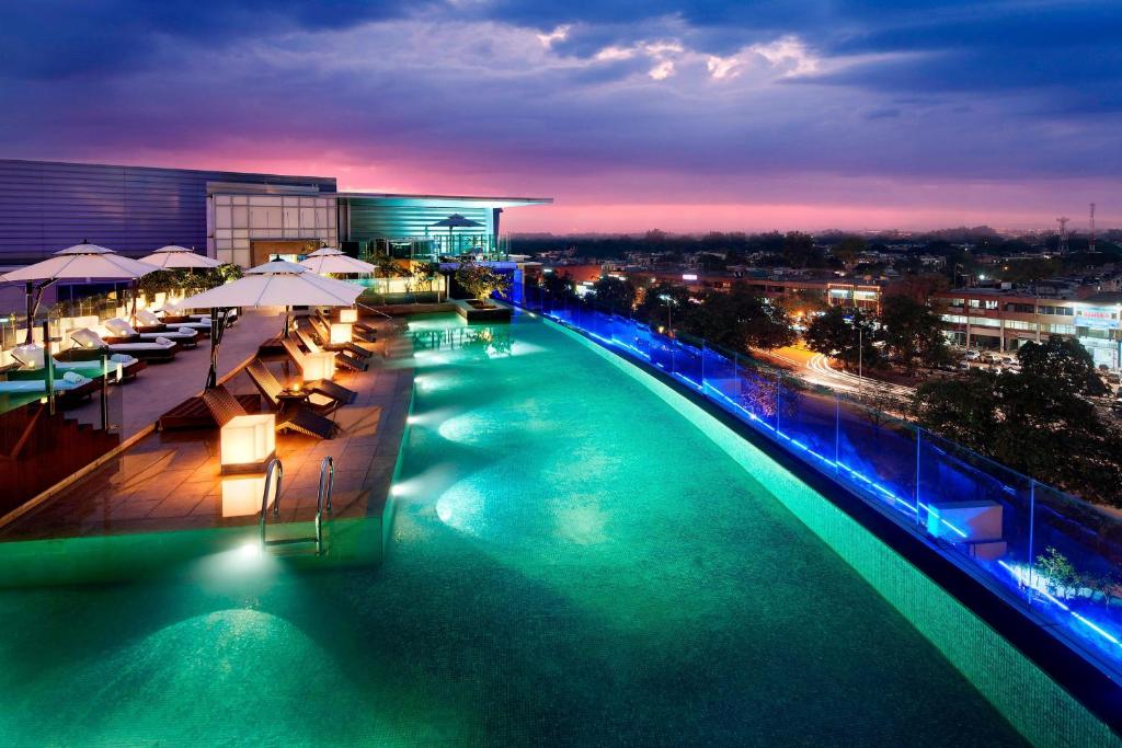 a pool on the top of a building at night at JW Marriott Hotel Chandigarh in Chandīgarh