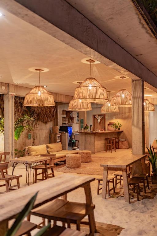 a large room with tables and chairs and chandeliers at Villa Mango Jeri in Jericoacoara