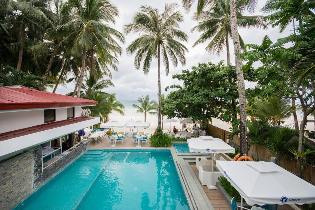 - Vistas a la piscina de un complejo con palmeras en White House Beach Resort, en Boracay