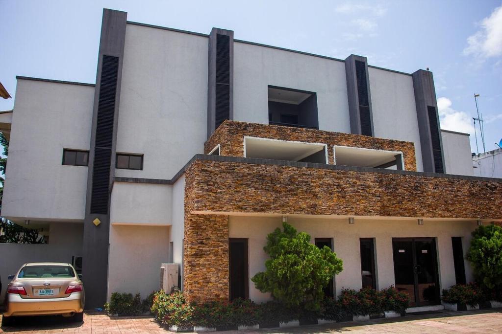 a car parked in front of a building at S & S Hotel & Suites in Lagos