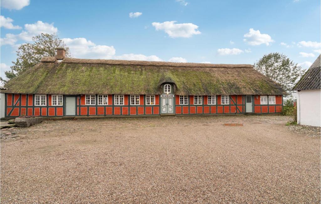 a large red building with a grass roof at Cozy Apartment In Faaborg With Kitchen in Fåborg