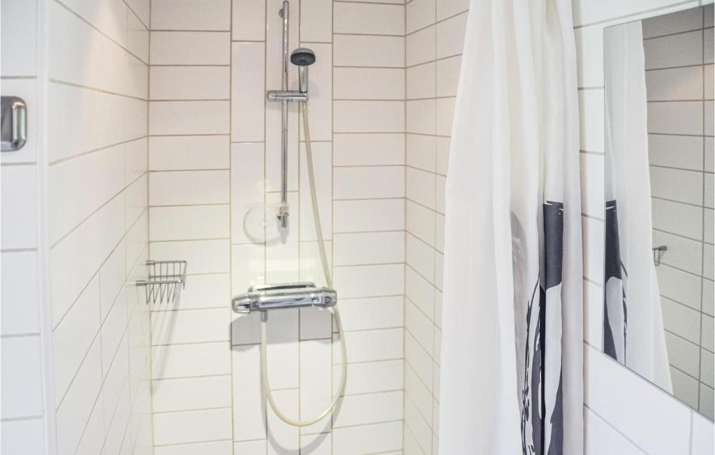 a shower in a bathroom with a shower curtain at Amazing Home In Henn With 1 Bedrooms And Wifi in Henån
