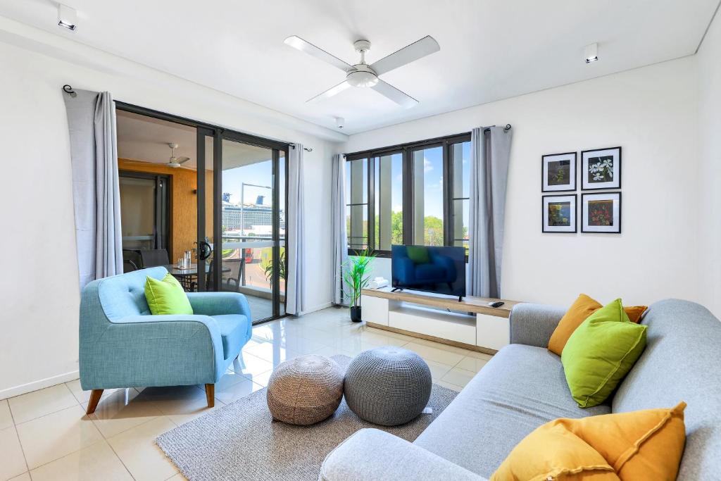 a living room with a couch and two chairs at Cute & Cosy Darwin Waterfront Apartment with Queen Bed in Darwin