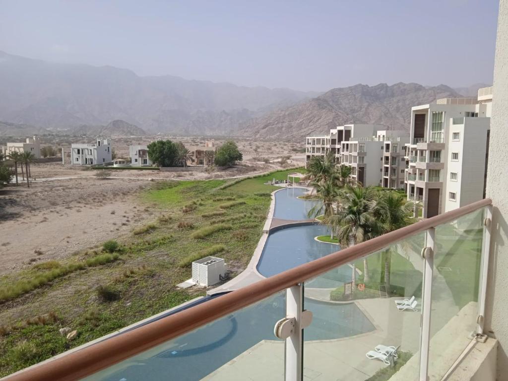 a view from the balcony of a apartment building with a pool at as sifah in Muscat