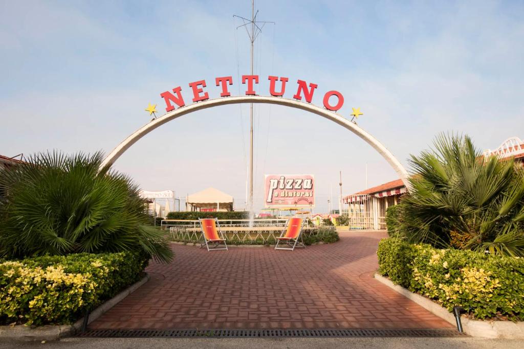 a sign that says neithonia in front of a building at Elena House Apartments in Viareggio