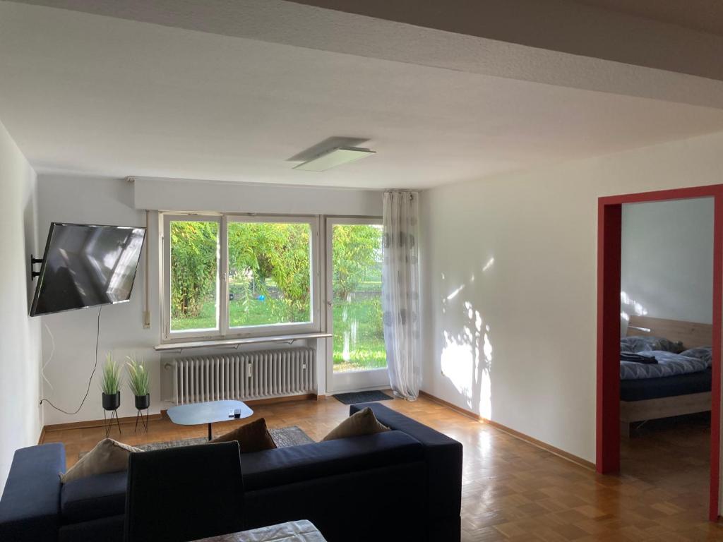 a living room with a couch and a large window at 2 room apartment with parking in Stuttgart in Stuttgart