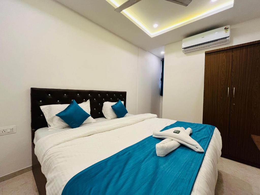a bedroom with a bed with a towel on it at WELCOME VISTA in Navi Mumbai
