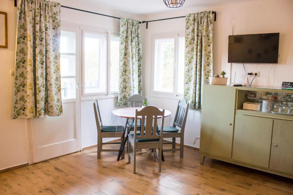 a kitchen and dining room with a table and chairs at Bükki csend vendégház in Bükkszentkereszt