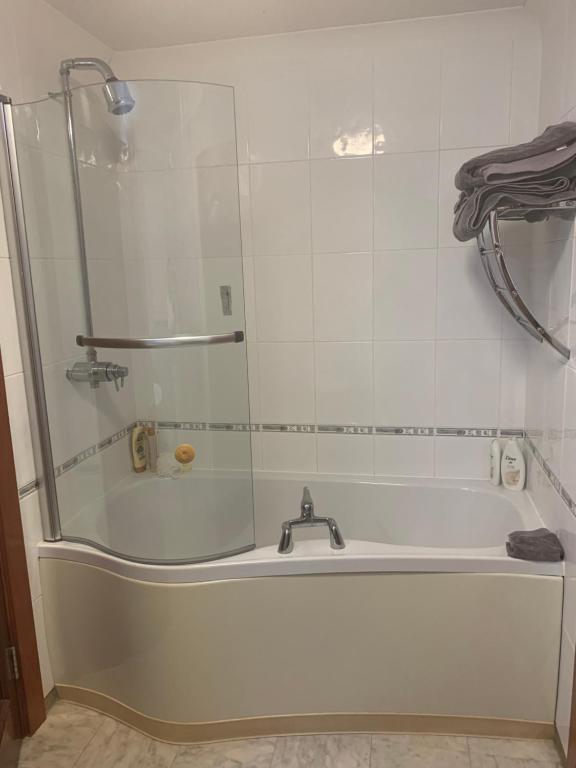 a white bath tub with a glass shower door at At The Beach in Stevenston