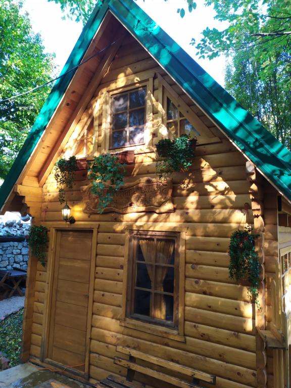 a log cabin with lights on the side of it at Brvnara Fairy Tale in Cetinje