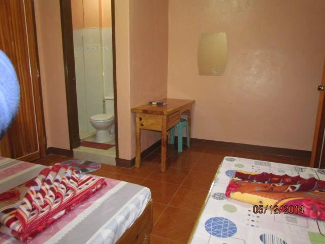 Postel nebo postele na pokoji v ubytování TRIPLE JS INN-SAGADA