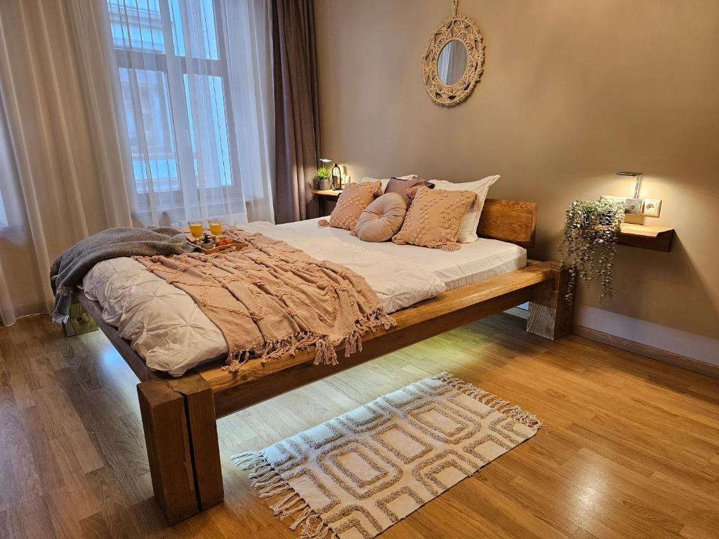 a bedroom with a large bed with pillows on it at Silversmith's Residence in Old Riga in Rīga