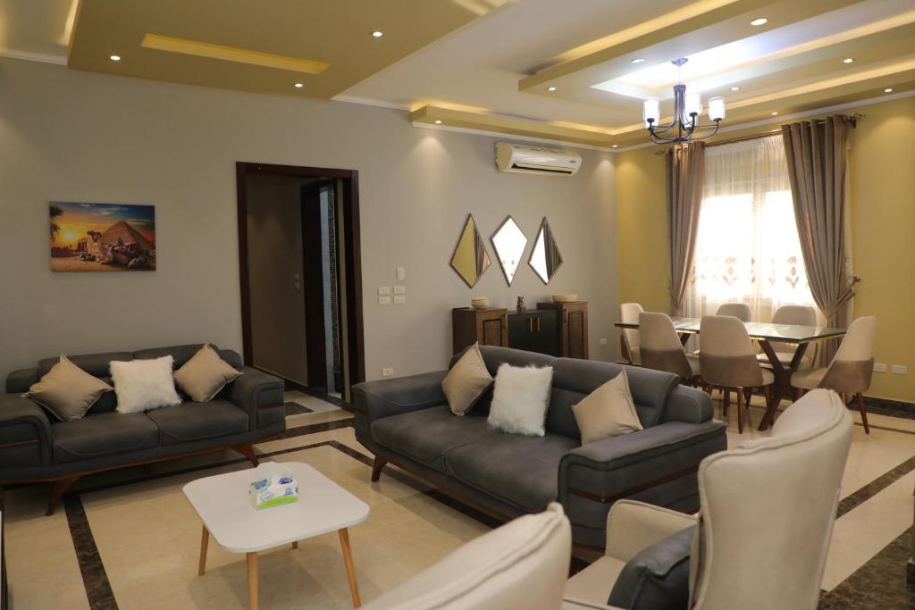 a living room with couches and a dining room at Luxurious apartment - New Cairo in Cairo