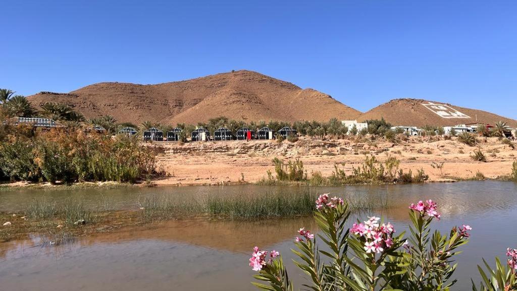 a body of water with mountains in the background at Camping , Maison d'hôte Bivouac hyatt-tata in Tatta