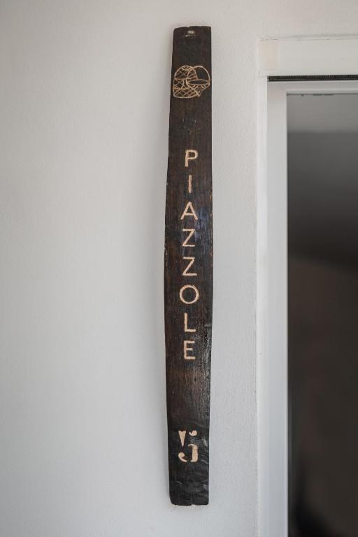 a wooden sign hanging on a wall at Cala Cala Rooms,Restaurant & Farm Experience in Procida