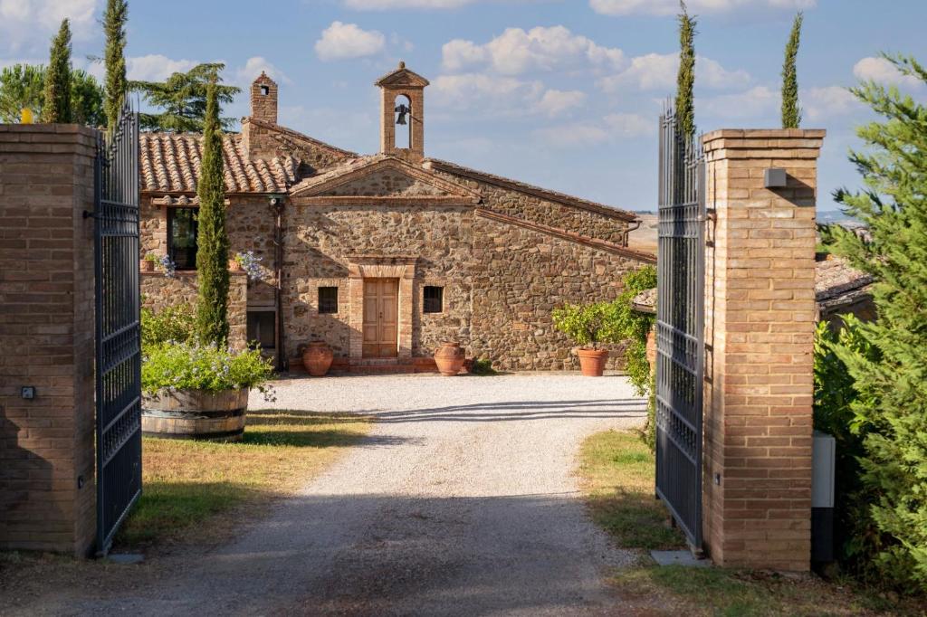 an entrance to an old stone building with a gate at Tenuta San Filippo in Montalcino