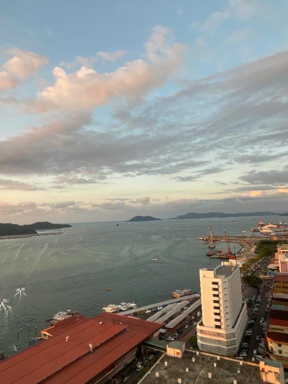 a view of a large body of water with a building at Borneo Staycation - The Shore in Kota Kinabalu