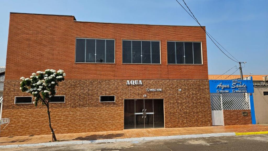 a red brick building with a cross on it at Pousada Aqua in Campo Grande