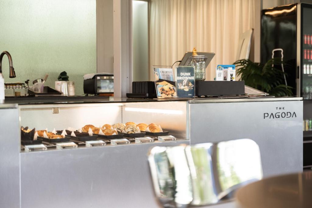 A pastry counter displays croissants and baked goods at The Pagoda Café.