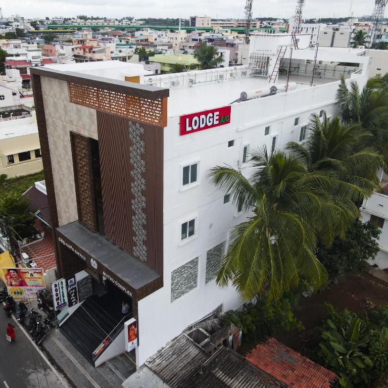 a building with a sign on the side of it at New Thai Residency in Dhārāpuram