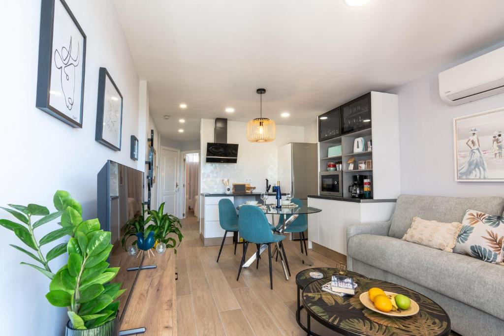 a living room with a couch and a table at OASIS PLAYA DEL INGLES 324 by Homestaygrancanaria in San Bartolomé de Tirajana