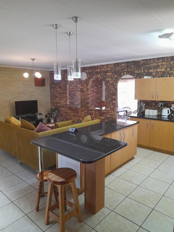 a kitchen with a table and a couch at Chappel Hide Out in Germiston