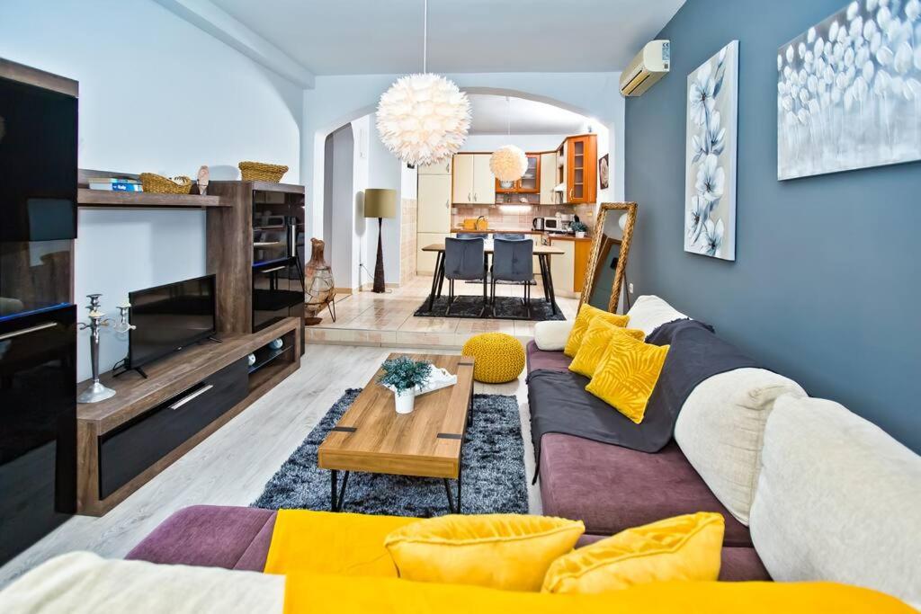 a living room with a couch and a table at Apartman Tino with two sunny terace in Hvar