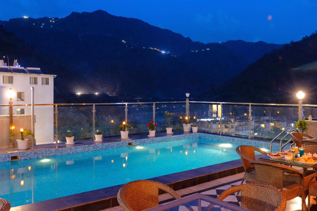 a pool on the roof of a hotel at night at Vyom Boutique Hotel Rishikesh in Rishīkesh