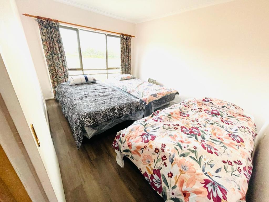 a bedroom with two beds and a window at Ross Creek farm Stay in Ross Creek