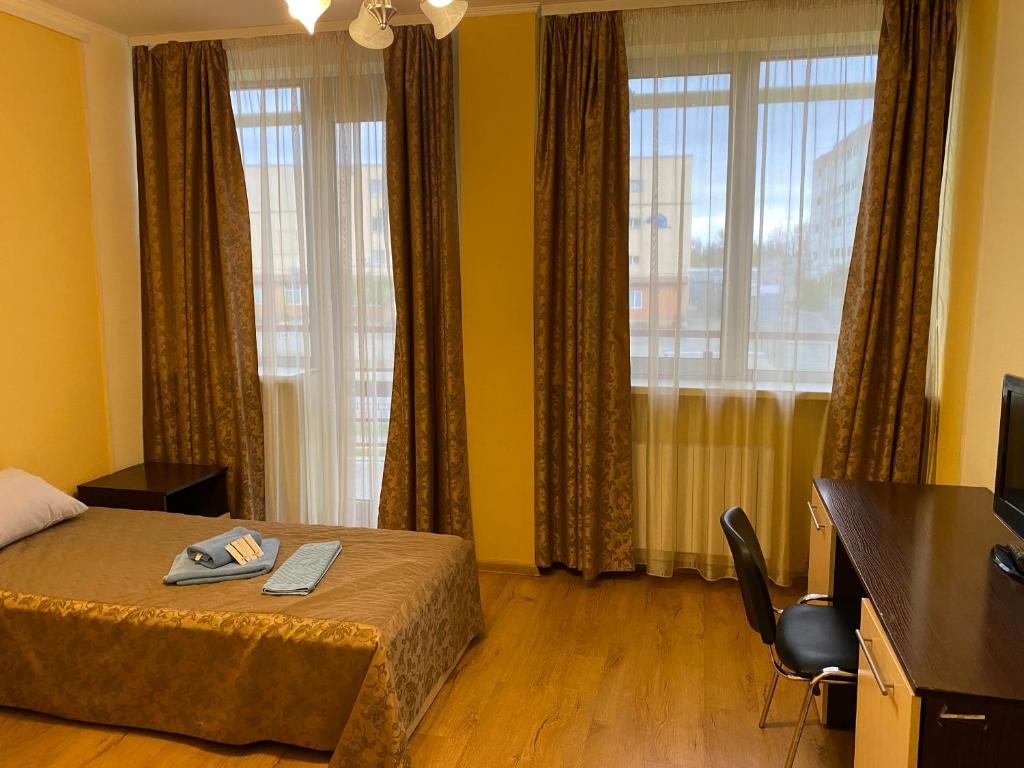 Postel nebo postele na pokoji v ubytování Hotel Obolon-Arena