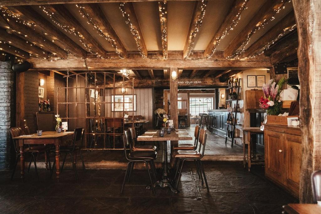 a dining room with wooden tables and chairs at The Ship Inn in Rye
