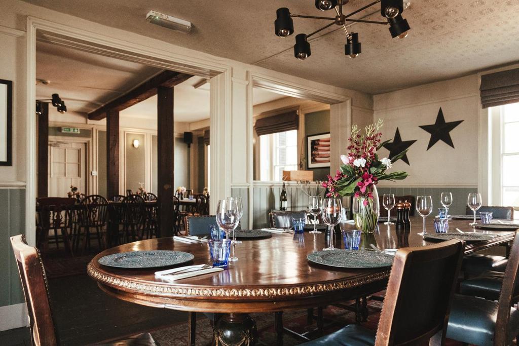 a dining room with a large wooden table with stars on the wall at The Ship Inn in Rye