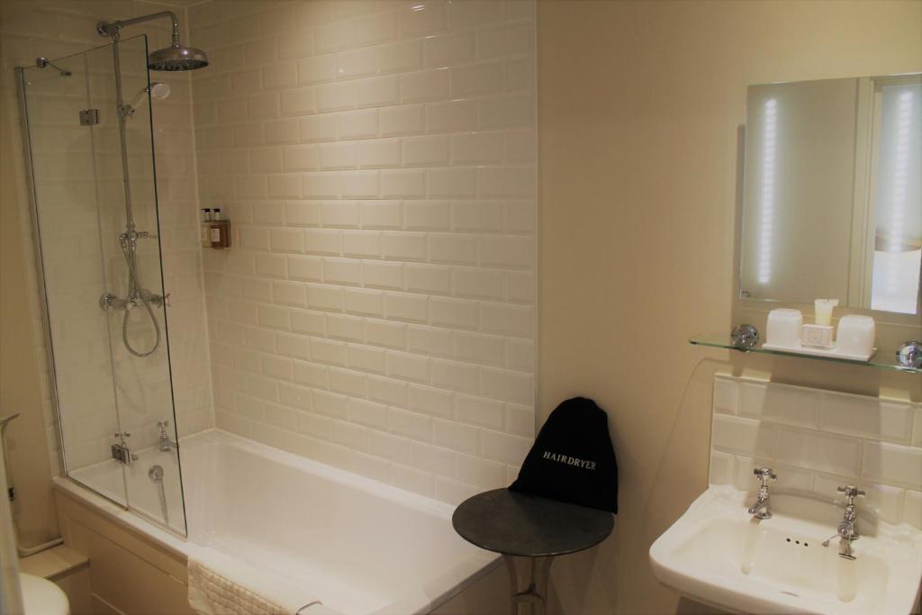a bathroom with a tub and a sink and a shower at The Ship Inn in Rye