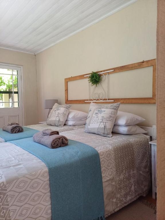 two beds sitting next to each other in a bedroom at Booiskraal Farm Stay Accommodation in Beaufort West