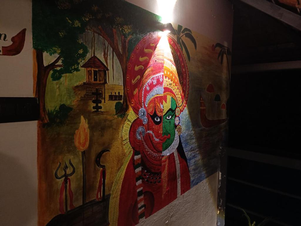 a painting of a god on the side of a wall at Anandam Woods - A Heritage single Room for couple-small family in Vaikom